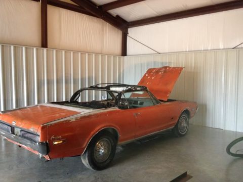 1968 Mercury Cougar - This 1968 Mercury Cougar convertible is parked inside a metal building with its hood open.
