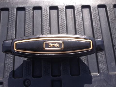 1968 Mercury Cougar - This emblem, a cougar silhouette on a black background with gold trim, is consistent with a 1968 Mercury Cougar.