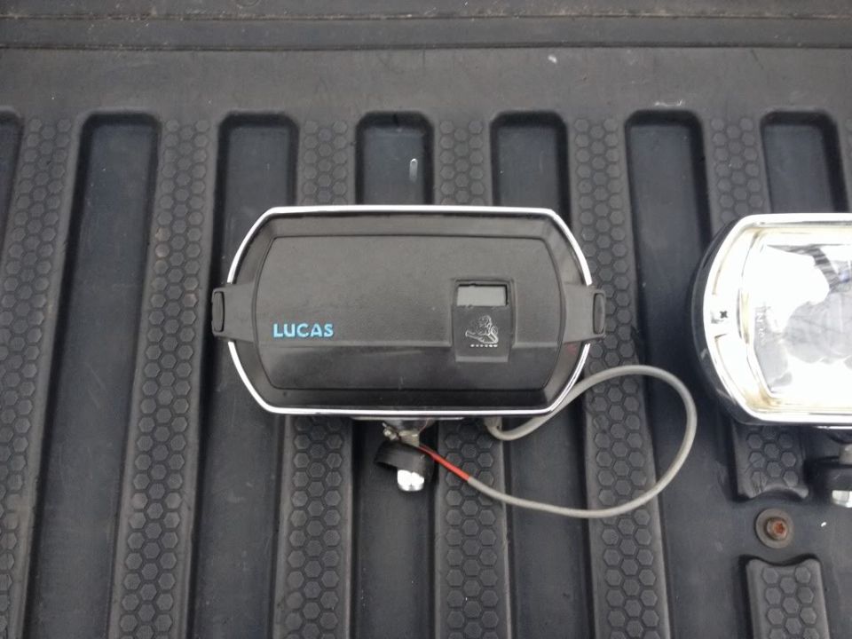 Lucas fog light with a small digital display and a coiled wire
