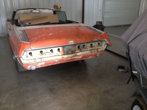 1968 Mercury Cougar - Rear view of a 1968 Mercury Cougar convertible undergoing restoration in a garage.