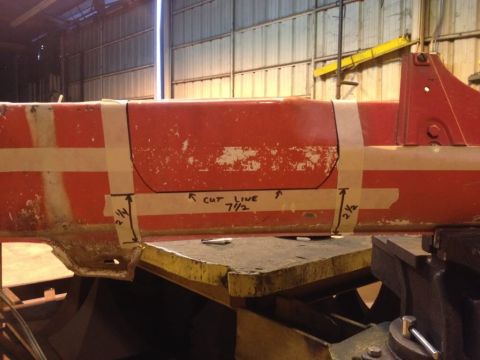 1968 Mercury Cougar - A section of a red metal beam is marked for cutting with tape and handwritten measurements.