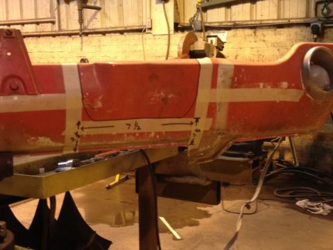 1968 Mercury Cougar - A red car body panel is marked with tape and measurements, possibly for repair or modification.