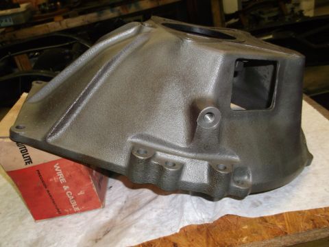1963 Ford Galaxie - Cast iron part and an Autolite box are on a workbench.