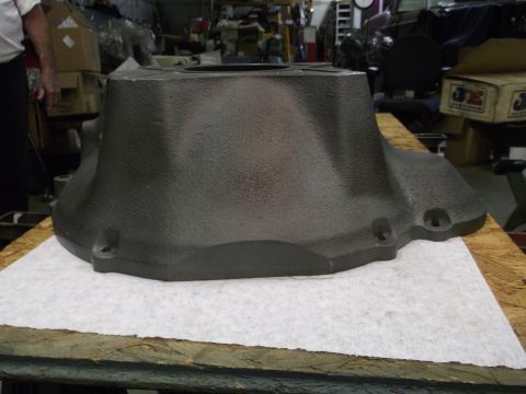 1963 Ford Galaxie - A large, dark gray, cast iron component sits on a workbench, possibly a transmission bell housing.