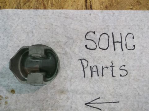 1963 Ford Galaxie - A single engine piston is shown on a white cloth with handwritten text indicating it is SOHC parts.