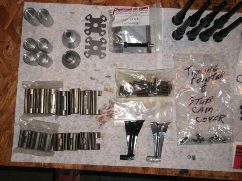 1963 Ford Galaxie - Various engine components are organized on a surface, including lifters, timing pointer, stub cam cover, and spark plug boots.