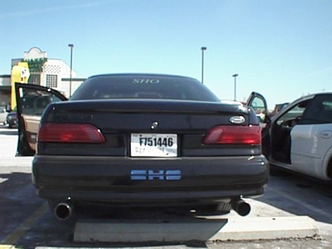 1999 Ford Taurus - Rear view of a 1999 Ford Taurus SHO parked in a lot, showing its dual exhaust and license plate.