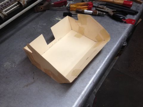1968 Mercury Cougar - A handmade cardboard box sits on a workbench with various tools in the background.