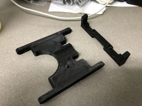 1989 Ford Bronco - Two black 3D printed plastic components are shown on a neutral surface, suggesting they are custom-made or replacement parts.