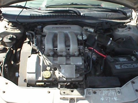 1999 Ford Taurus - The engine bay of a 1999 Ford Taurus is captured from a top-down perspective.
