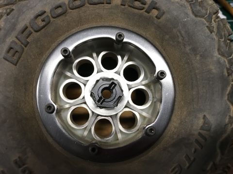 1989 Ford Bronco - A detailed view of a tire and wheel assembly, showing the tread pattern and rim construction.