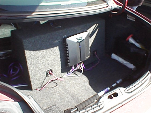 Trunk with subwoofer box and amplifier, wires connected