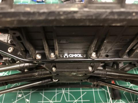 1989 Ford Bronco - The underside of a remote-controlled vehicle shows the 'AXIAL' branding on its chassis.