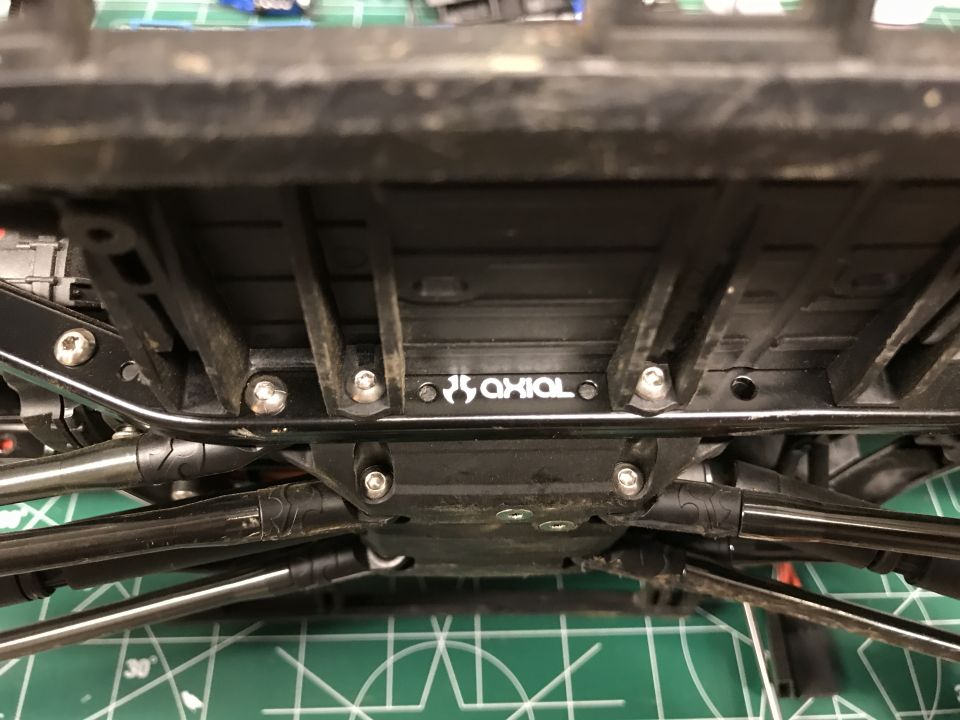 Underside of an RC car chassis with 'AXIAL' logo visible