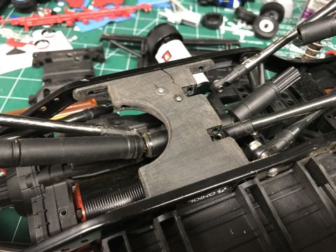 1989 Ford Bronco - Close-up view of a model car's internal chassis components, including suspension and drive shafts.
