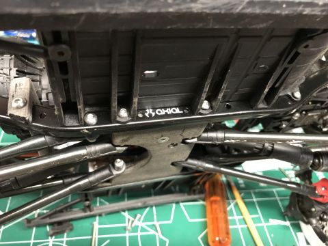 1989 Ford Bronco - Underside view of an RC car chassis, showing the Axial brand logo and suspension parts.