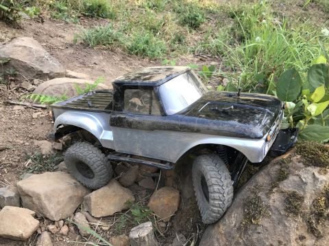 1989 Ford Bronco - This remote control truck is navigating a challenging rocky terrain.