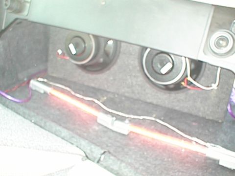 1999 Ford Taurus - Aftermarket speakers and neon light installed in a car's trunk.