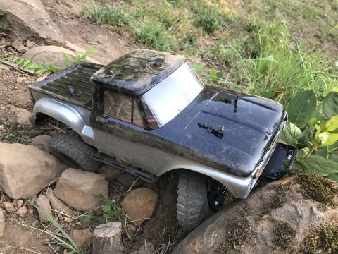 1989 Ford Bronco - A toy truck body is shown from a 3/4 front angle, navigating a rocky terrain.