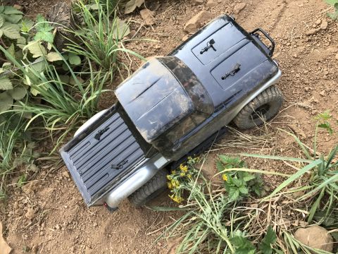 1989 Ford Bronco - A toy truck is parked on a dirt path surrounded by vegetation.