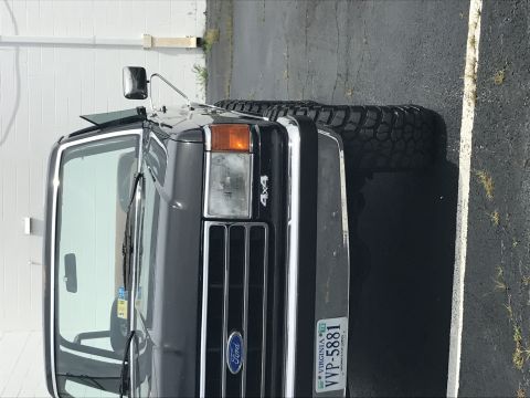 1990 Ford Bronco - This 1990 Ford Bronco is shown from a three-quarter front angle, highlighting its grille and 4x4 badging.