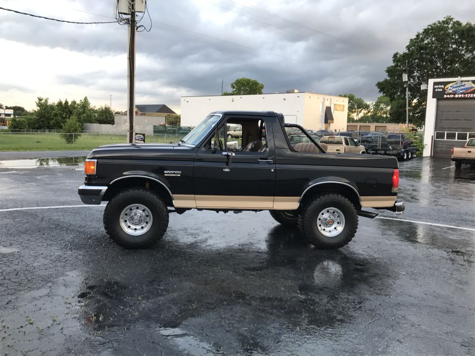 Black 1990 Ford Bronco side view with tan trim
