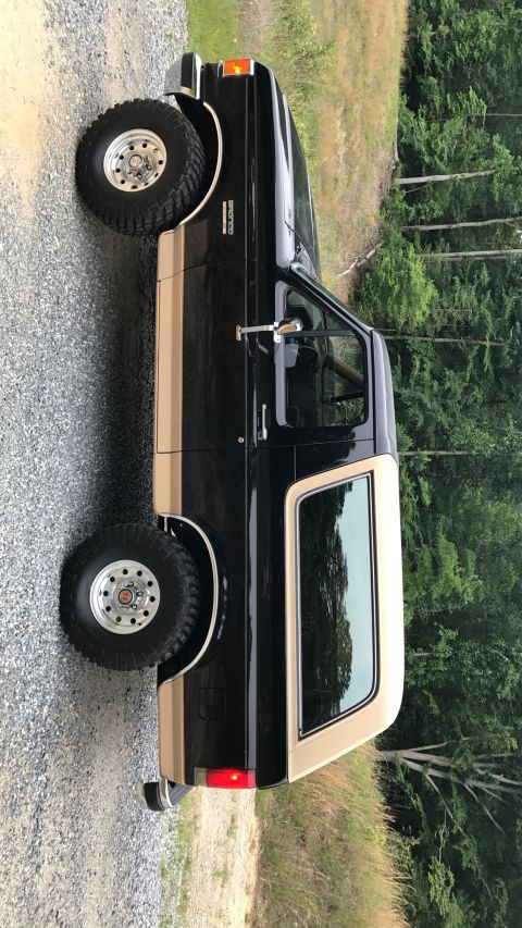 1990 Ford Bronco - Side view of a 1990 Ford Bronco with a two-tone paint scheme.