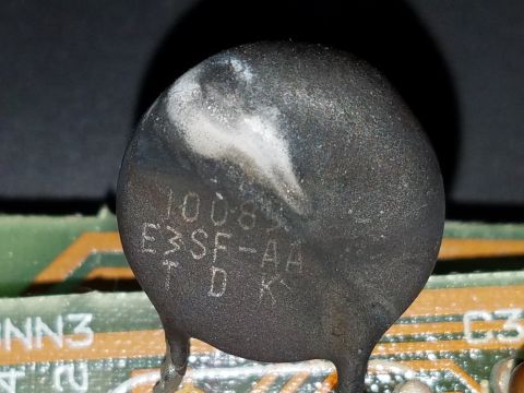 1994 Ford Bronco - A close-up view of a damaged electronic component with visible text markings on a circuit board.