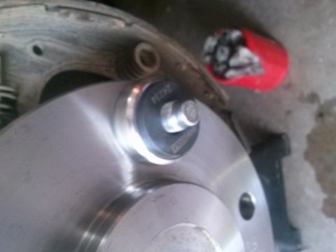 1996 Ford Bronco - Detail of a vehicle's brake rotor and drum assembly, with a part number visible on a component.