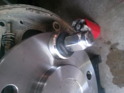 1996 Ford Bronco - Close-up of a vehicle's wheel hub and brake drum assembly, with a lug nut installed.
