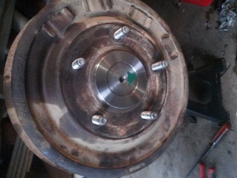 1996 Ford Bronco - Brake drum with wheel studs, likely from a truck or SUV, undergoing a rebuild.
