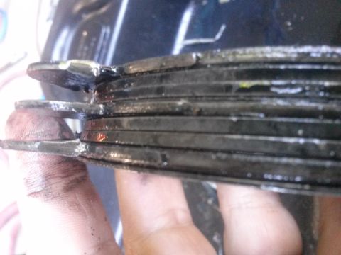 1996 Ford Bronco - Close-up of heavily worn clutch plates, indicating a need for replacement.