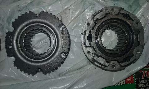 1995 Ford Bronco - Two transfer case components are shown, one with visible text reading "CEGE" and the other with a more complex locking mechanism.