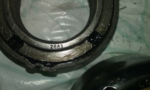 1995 Ford Bronco - A close-up view of a metal bearing part, showing the stamped number 2883.