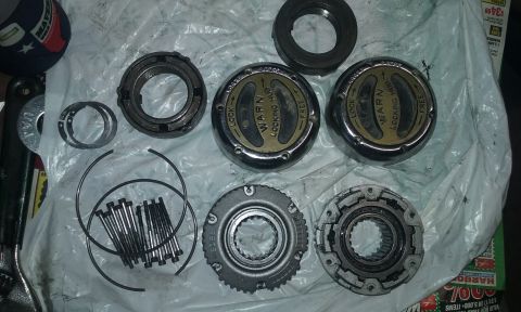 1995 Ford Bronco - A collection of Warn locking hubs and other drivetrain components are displayed, ready for installation or repair.