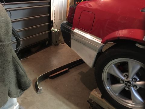 1983 Ford Mustang - The rear of a red car, likely a 1983 Ford Mustang, is shown in a garage with its bumper removed.