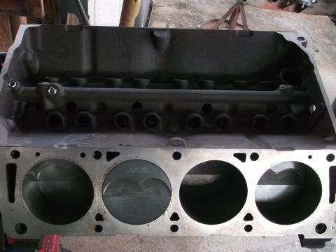 1967 Ford Mustang - Close-up view of an engine block, revealing the pistons within the cylinders.