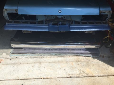 1975 Chevrolet Chevelle - The rear of a blue 1973 Chevrolet Chevelle with its bumper removed, and a separate chrome bumper placed underneath.