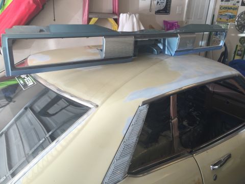 1975 Chevrolet Chevelle - A blue grille assembly is placed on the roof of a cream-colored car, which appears to be undergoing restoration.