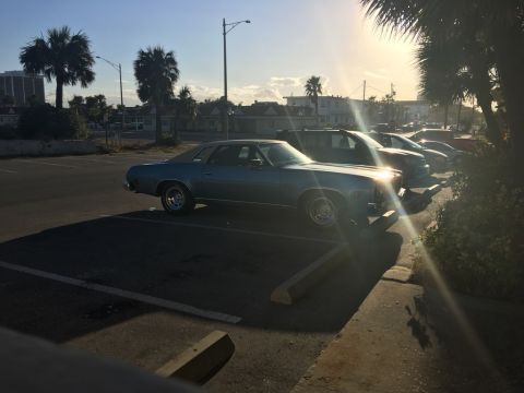 1975 Chevrolet Chevelle - Side view of a 1975 Chevrolet Chevelle coupe parked in a lot during the day.