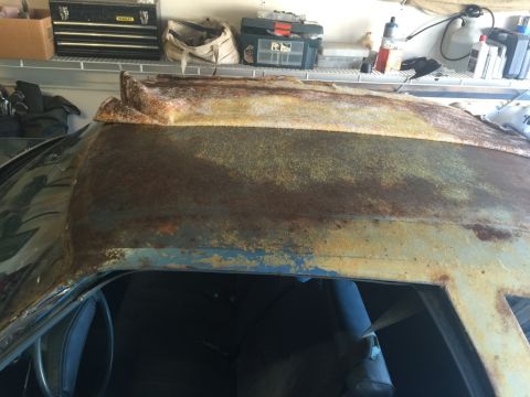 1975 Chevrolet Chevelle - Extensive rust covers the roof and exterior panels of this car, with the interior partially visible.