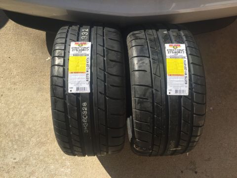 1975 Chevrolet Chevelle - Two new performance tires are displayed, each with detailed information labels on their sidewalls.