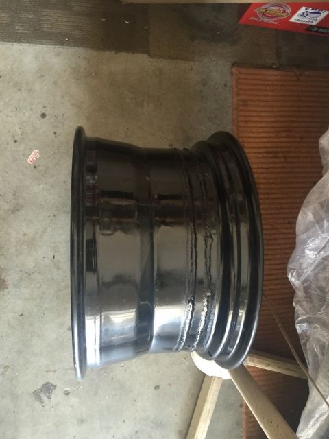 1975 Chevrolet Chevelle - A black steel wheel is shown from the side, resting on the ground.