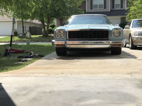 1975 Chevrolet Chevelle - A light blue 1975 Chevrolet Chevelle is parked on a driveway with a second car to its right.