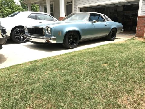 1975 Chevrolet Chevelle - This 1975 Chevrolet Chevelle coupe is parked in a driveway next to another vehicle.