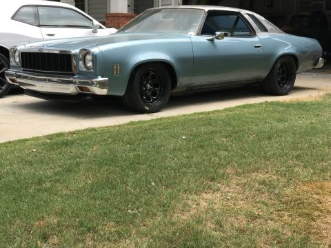 1975 Chevrolet Chevelle - This 1975 Chevrolet Chevelle coupe features a distinctive grille and silver roof, paired with black aftermarket wheels.