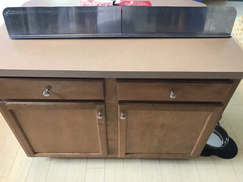 1975 Chevrolet Chevelle - A metal trim piece is shown on top of a kitchen counter with wooden cabinets below.