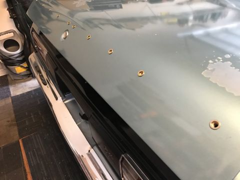 1975 Chevrolet Chevelle - Hood of a 1975 Chevrolet Chevelle shows multiple holes drilled into the metal.