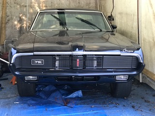 1969 Mercury Cougar - Front view of a black 1969 Mercury Cougar, showing its distinctive grille and headlights.