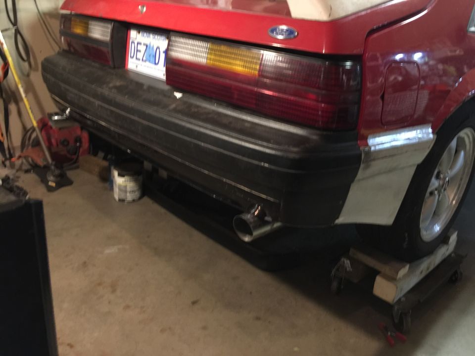 1983 Ford Mustang rear bumper with dual exhaust pipe and license plate DEZ 01